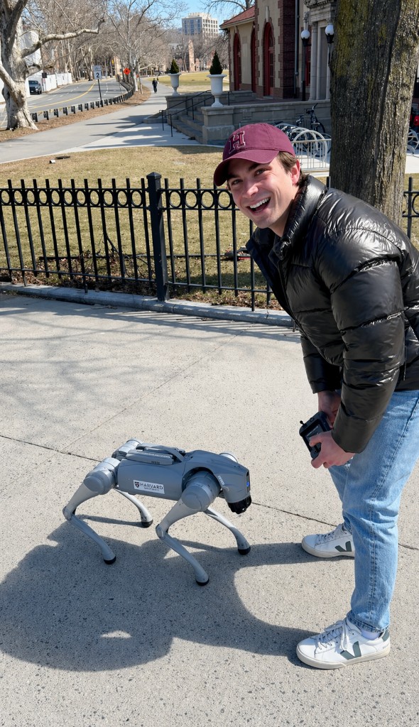 Constantin laughing next to a Boston Dynamics Spot robot at Harvard
