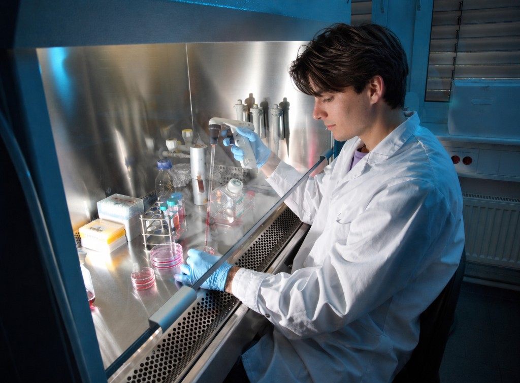 Constantin pipetting at a biosafety cabinet