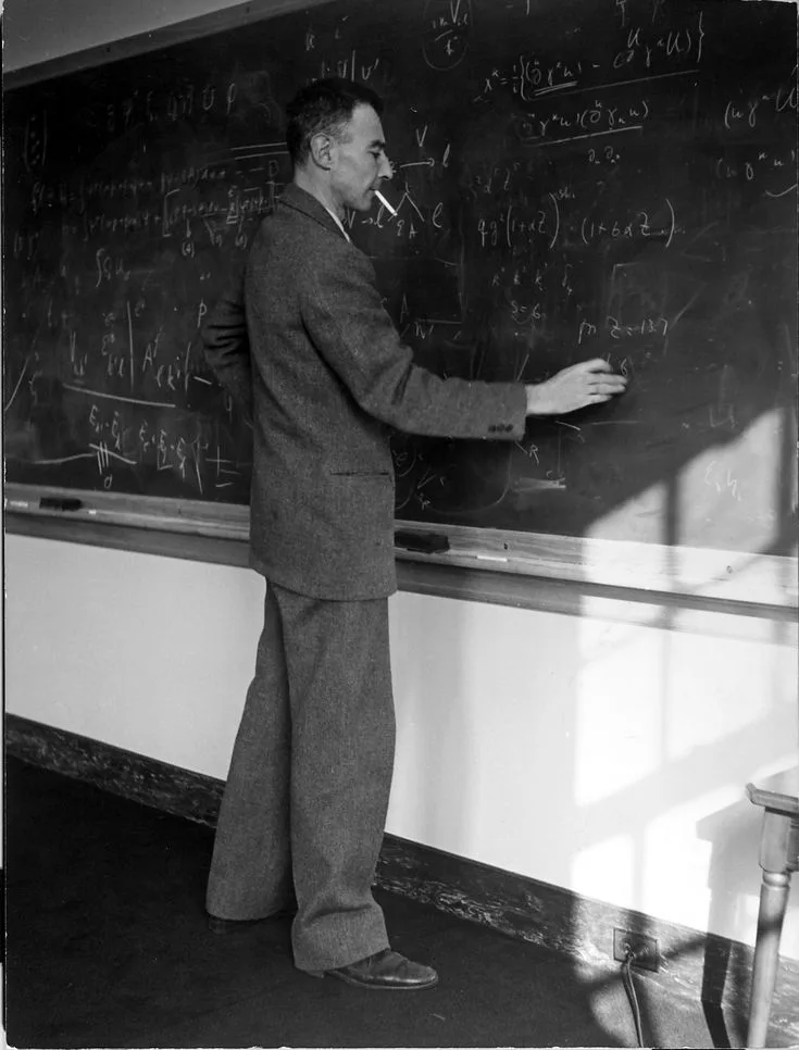 J. Robert Oppenheimer working through equations on a blackboard in 1947